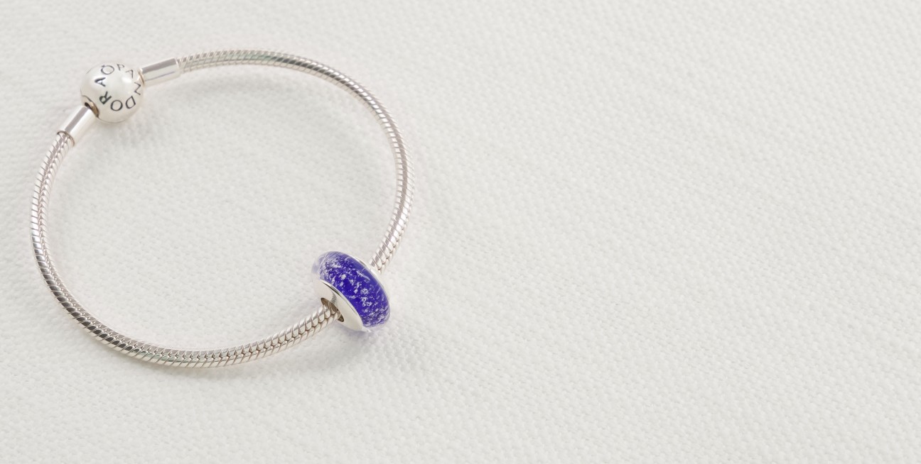 Charm with blue glass