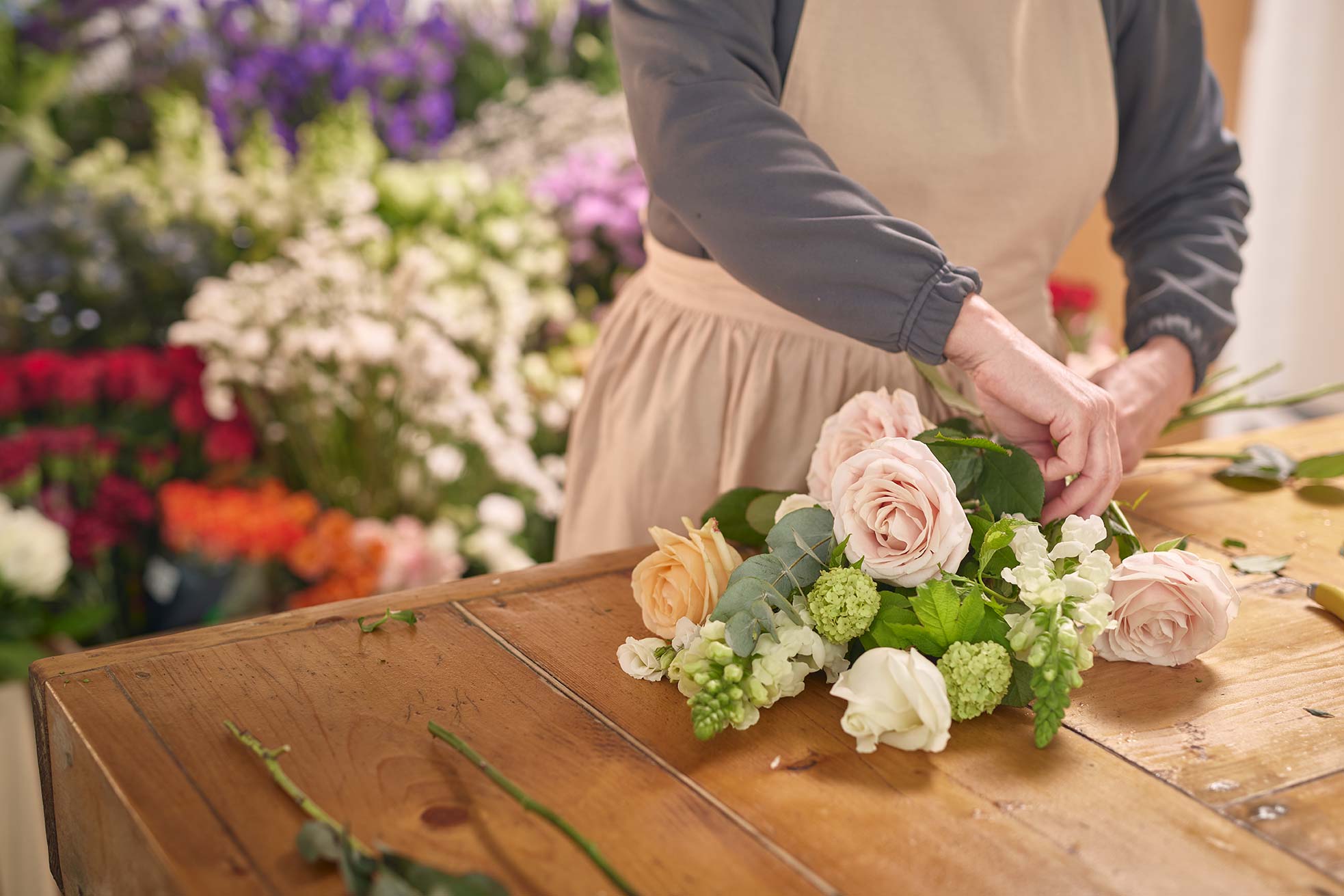 Florist hand tying flowers
