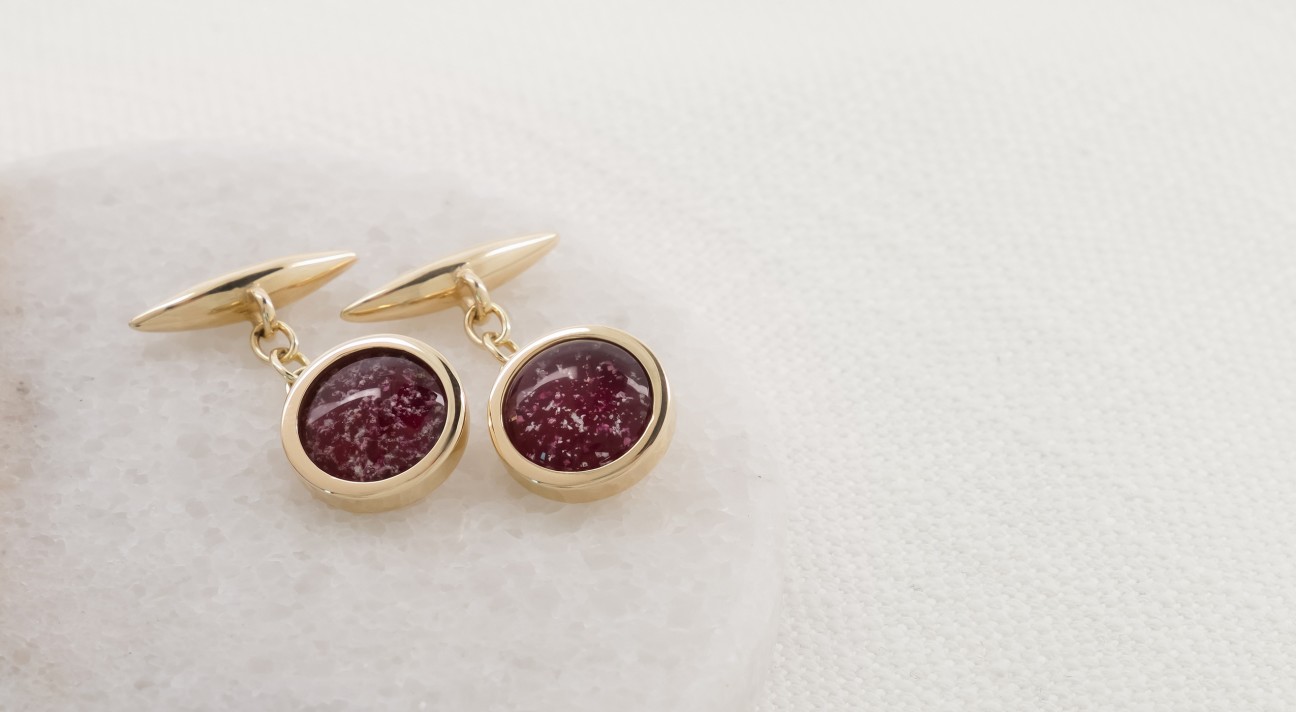 Gold cufflinks with red glass centres