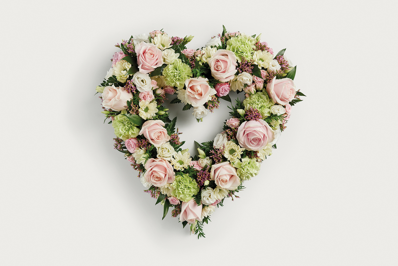 Pastel pink heart shaped floral display 