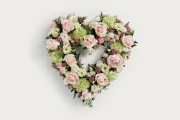 Pastel pink heart shaped floral display 