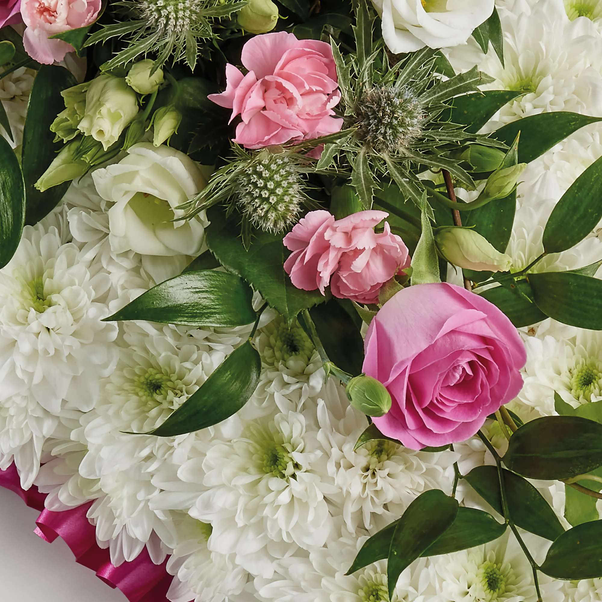 Zoomed in shot of pillow-shaped floral display in pink 