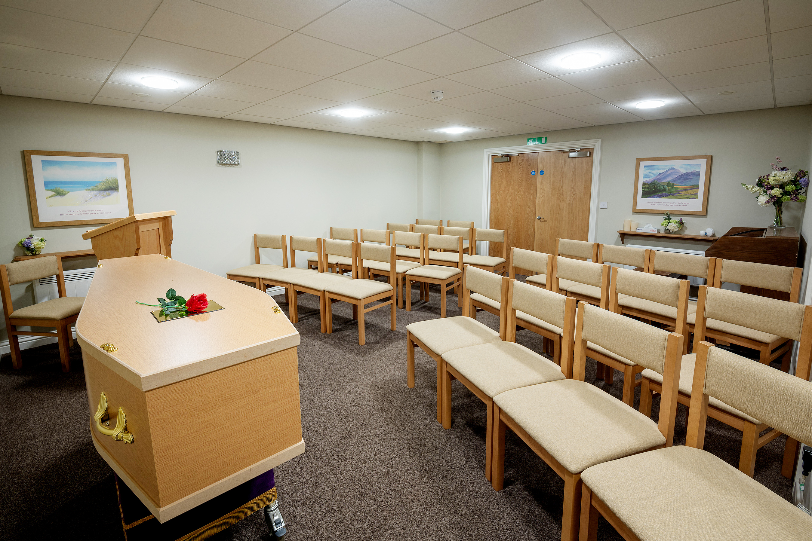 Funeral service venue with coffin at the front of the room