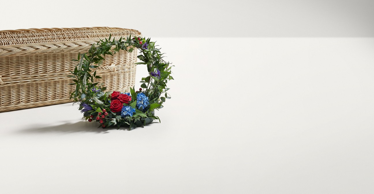 Climbing Flora Wreath shown with coffin