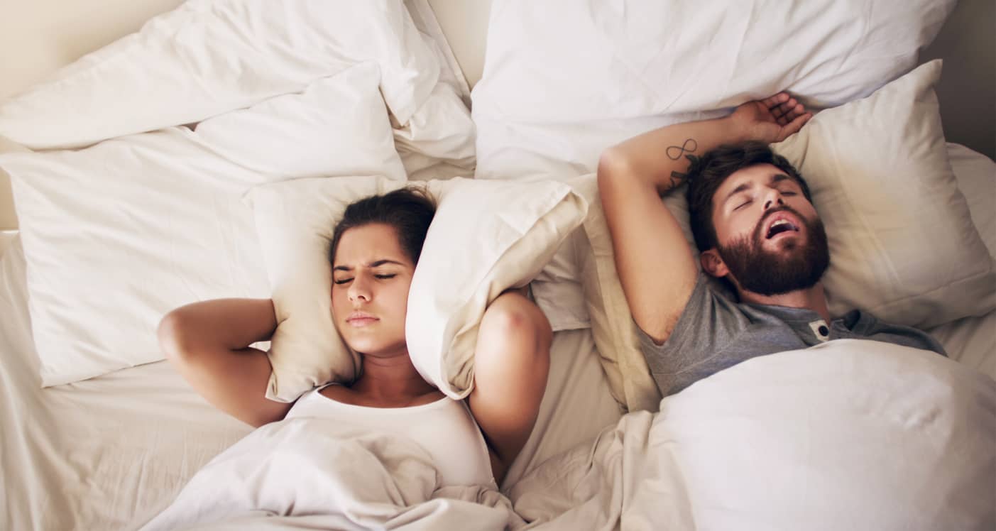Man snoring and keeping woman awake