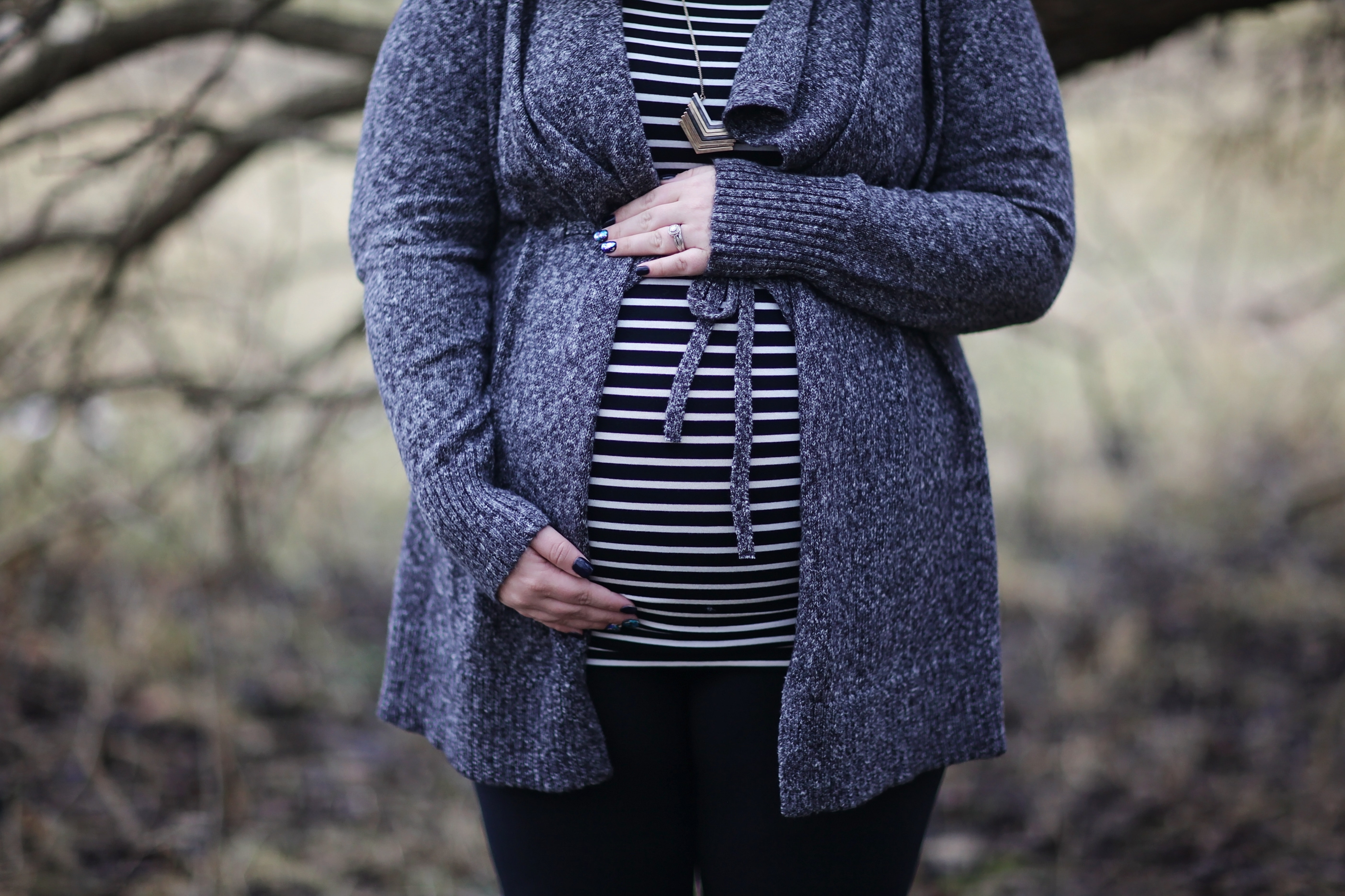 Photograph of a pregnant woman holding her belly