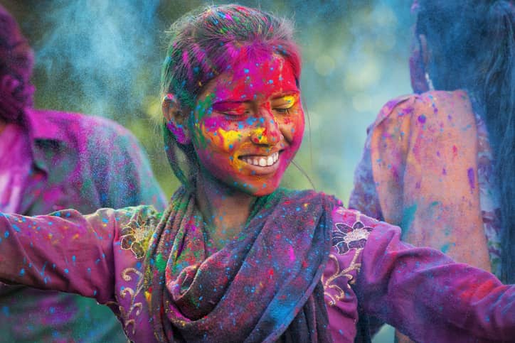 Young woman enjoying Holi festival