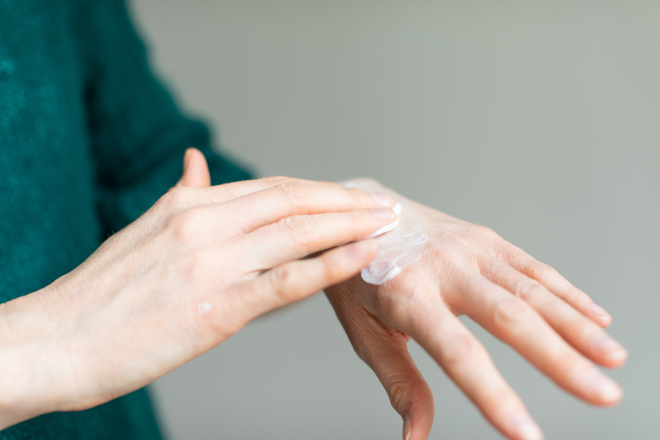 Woman applying gentle hand cream