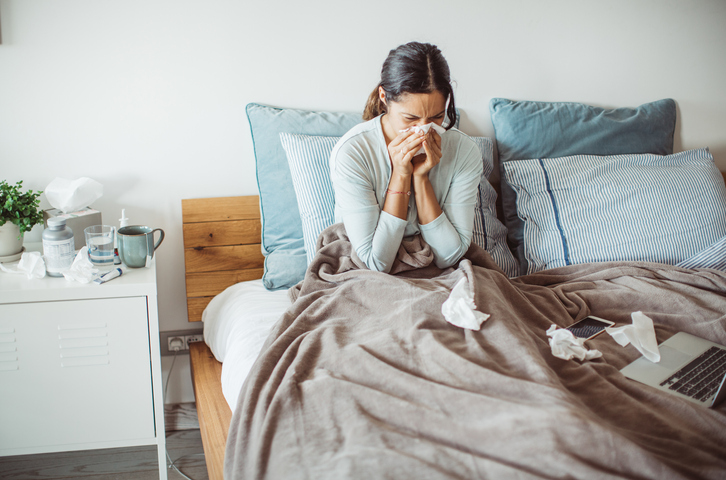 Woman with flu in bed