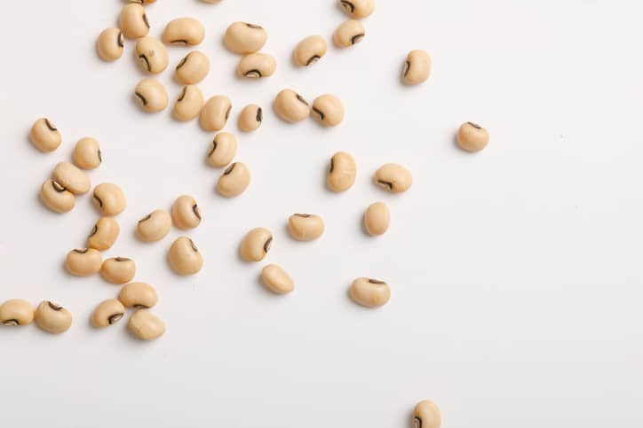 Black eyed peas scattered on a white background