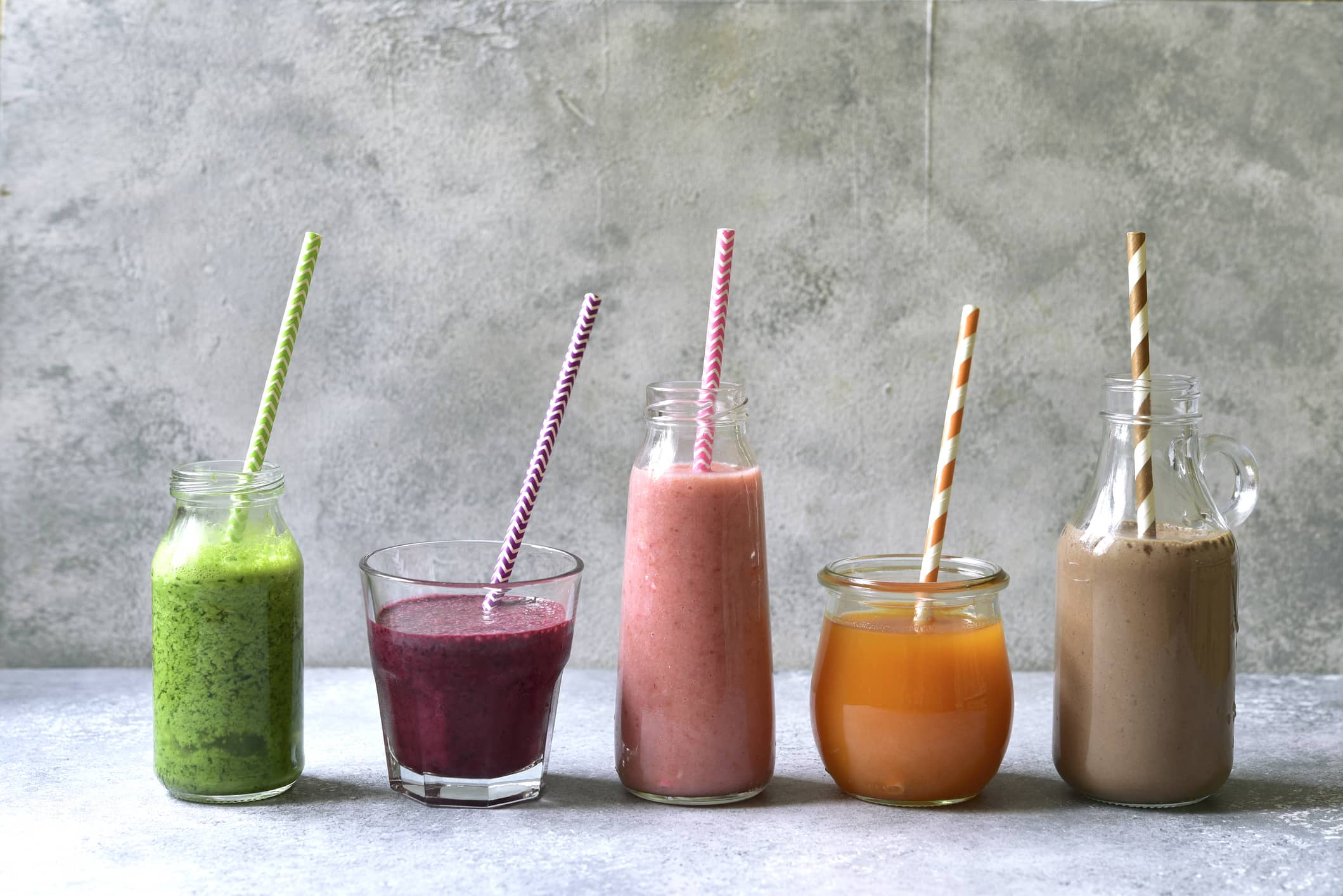 Assortment of colorful smoothies in a bottles