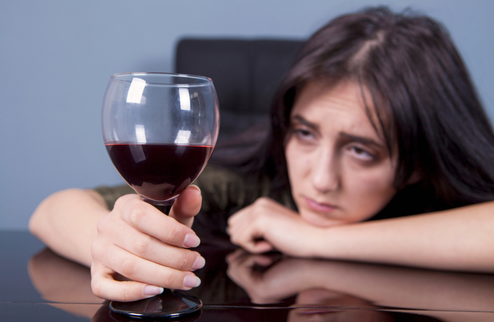 Woman gazing at red wine