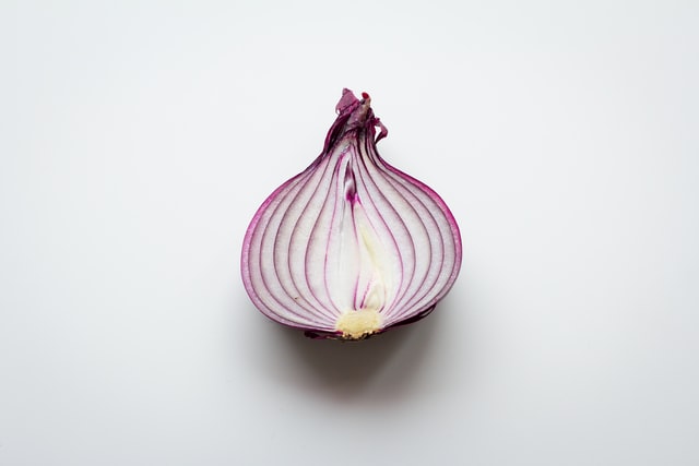Half a red onion on a white background