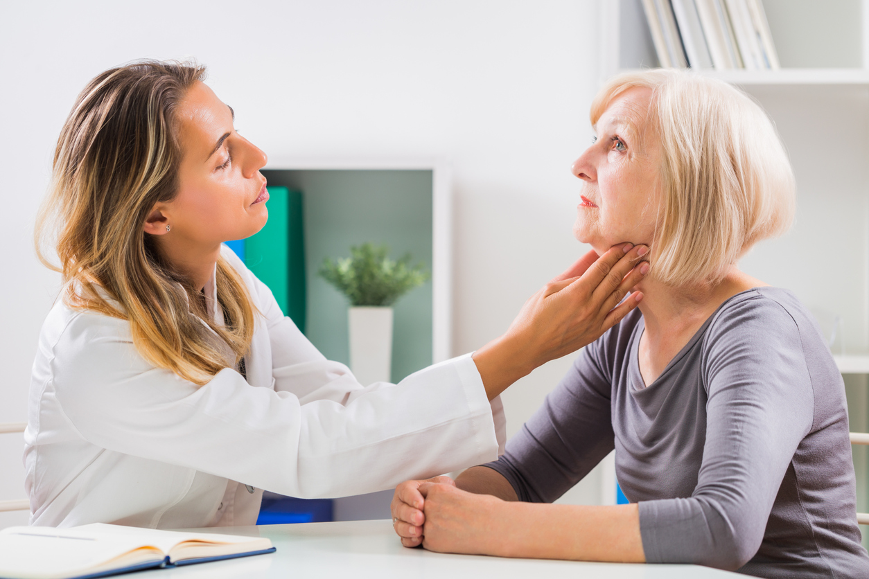 Doctor checking for thyroid problems