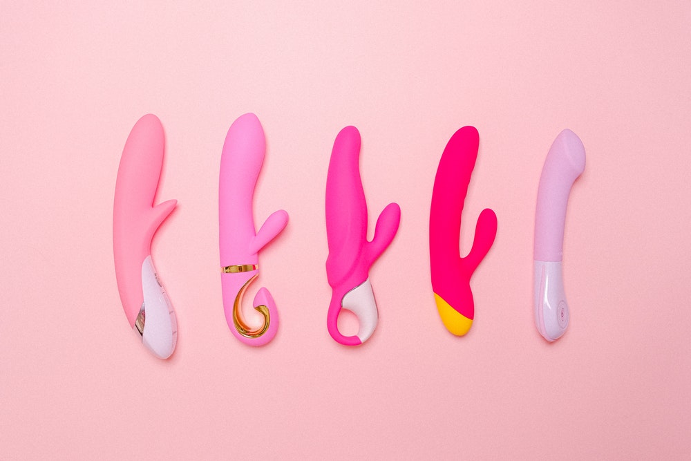 5 pink vibrators in a line on pink background