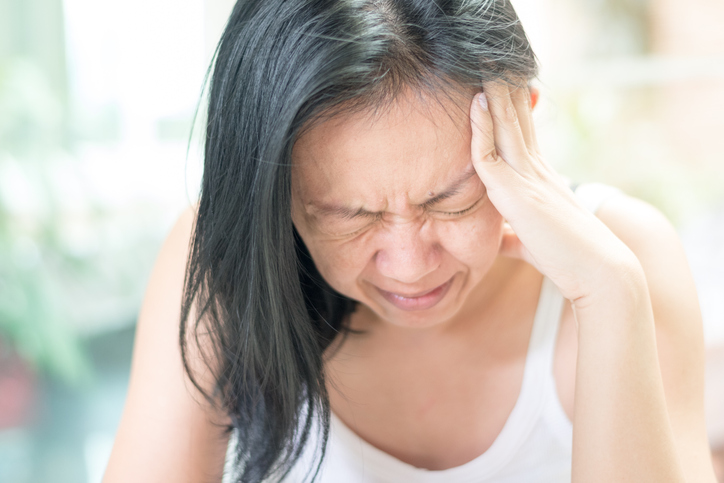 Woman with serious headache symptoms