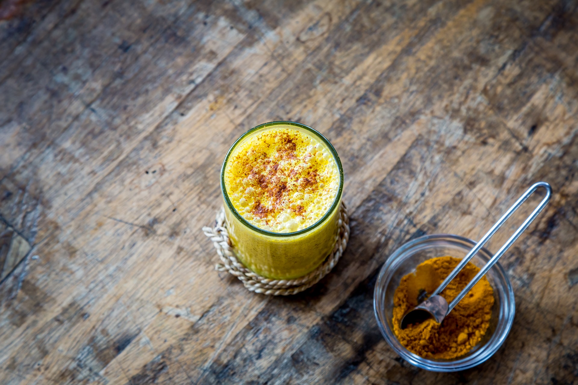 Glass of smoothie topped with turmeric