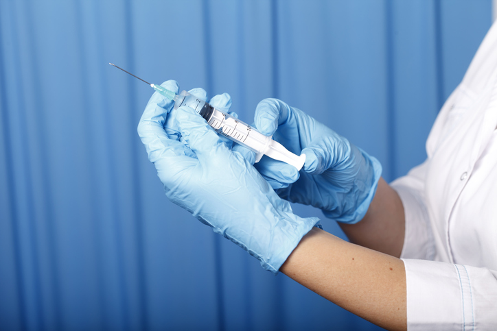 Doctor holding a syringe close-up
