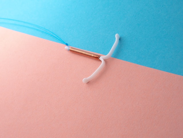 IUD with copper on blue and pink background