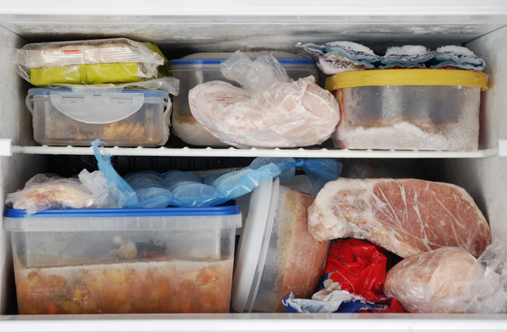 Open freezer with leftovers inside