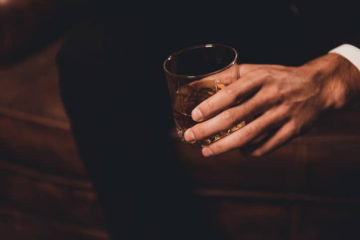 Man with a glass of alcohol in his hand