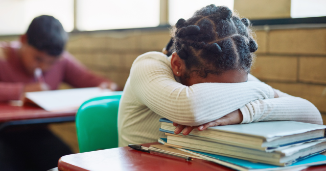 Child a sleep on top of books in classroom could be a sign of sleep problems in children