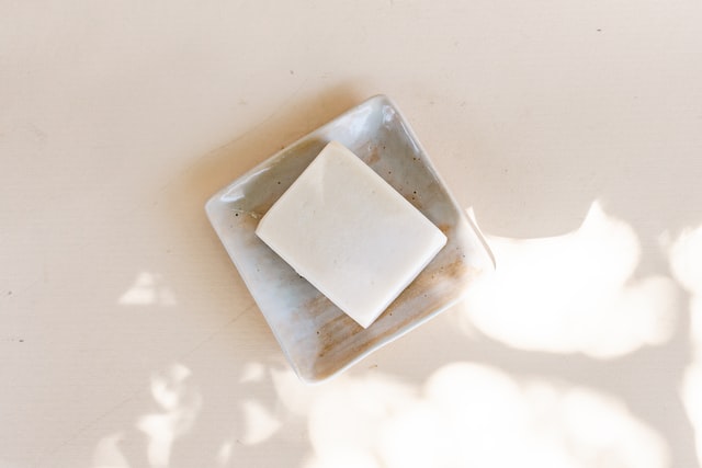 A bar of white, natural and gentle soap in a dish