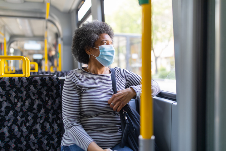 Woman with face mask travelling in the tram during Covid-19 outbreak