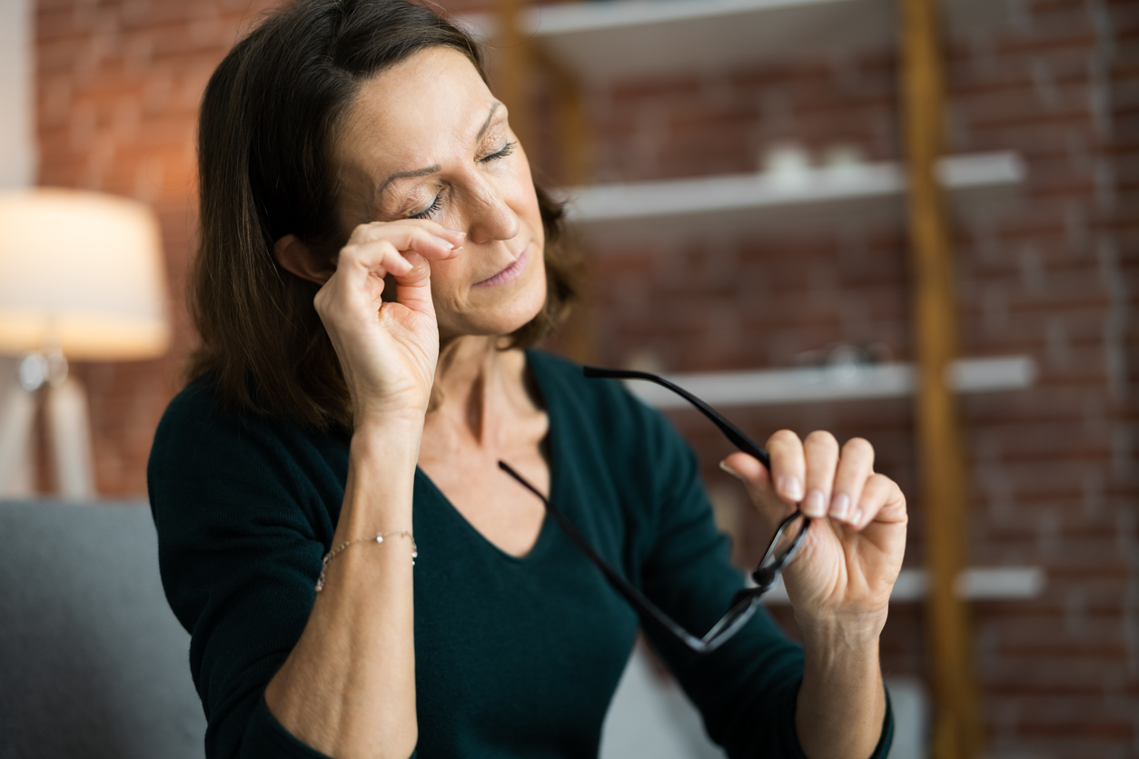 Woman itching her eyes
