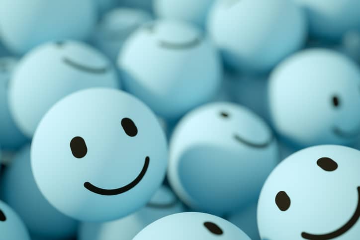Close up of blue ping pong balls with smiley faces