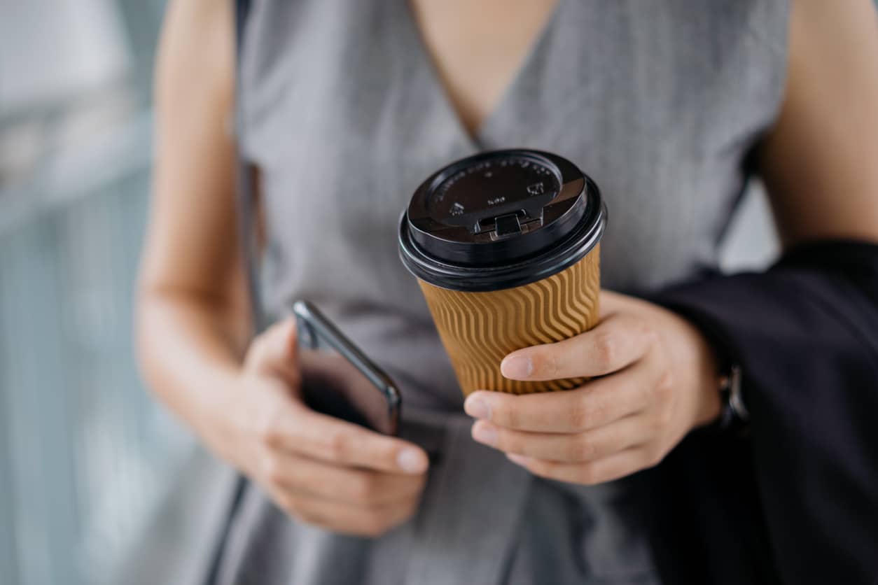 Woman holding a takeaway coffee
