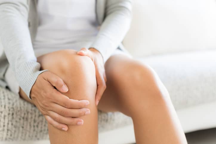 Woman with menopause joint pain in her knee