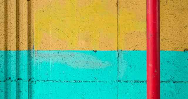 Red pipe on turquoise and yellow wall to show oesophageal rupture