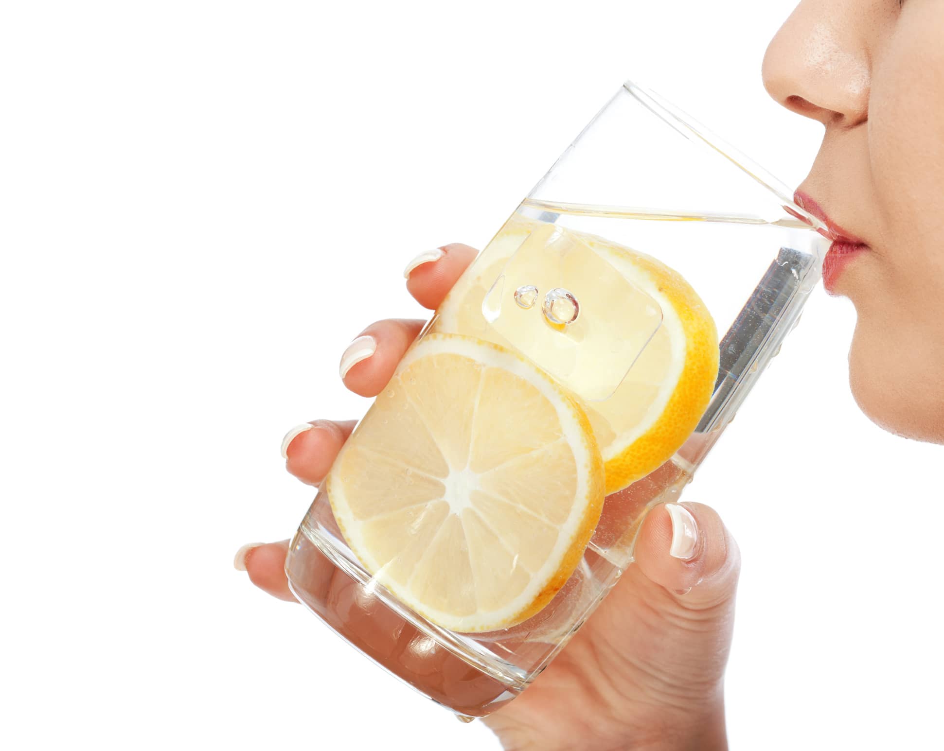Person drinking from a glass of water with lemon slices