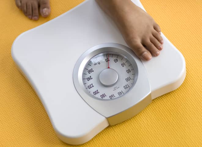 Person stepping onto weighing scales