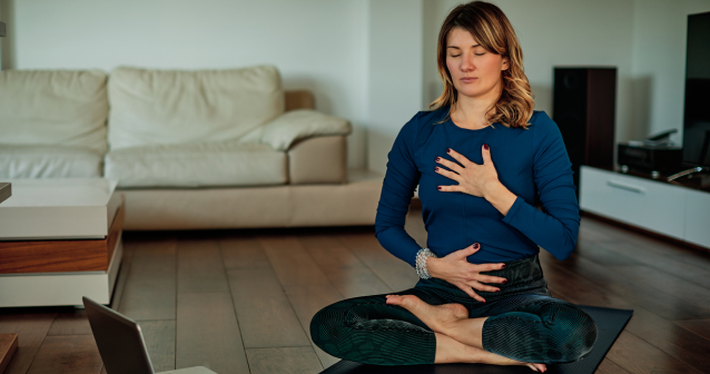 Woman practicing breathing exercises for long COVID