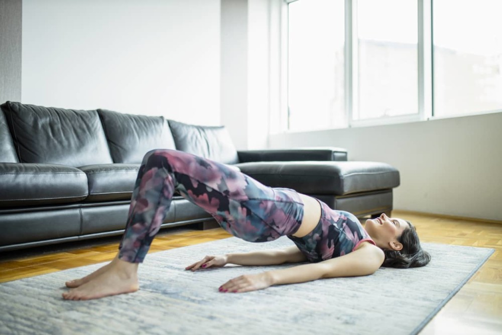 Person doing exercises to strengthen pelvic floor at home