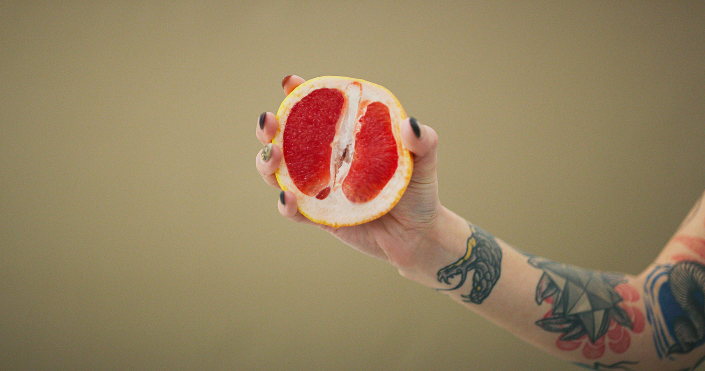 Woman holding half an orange