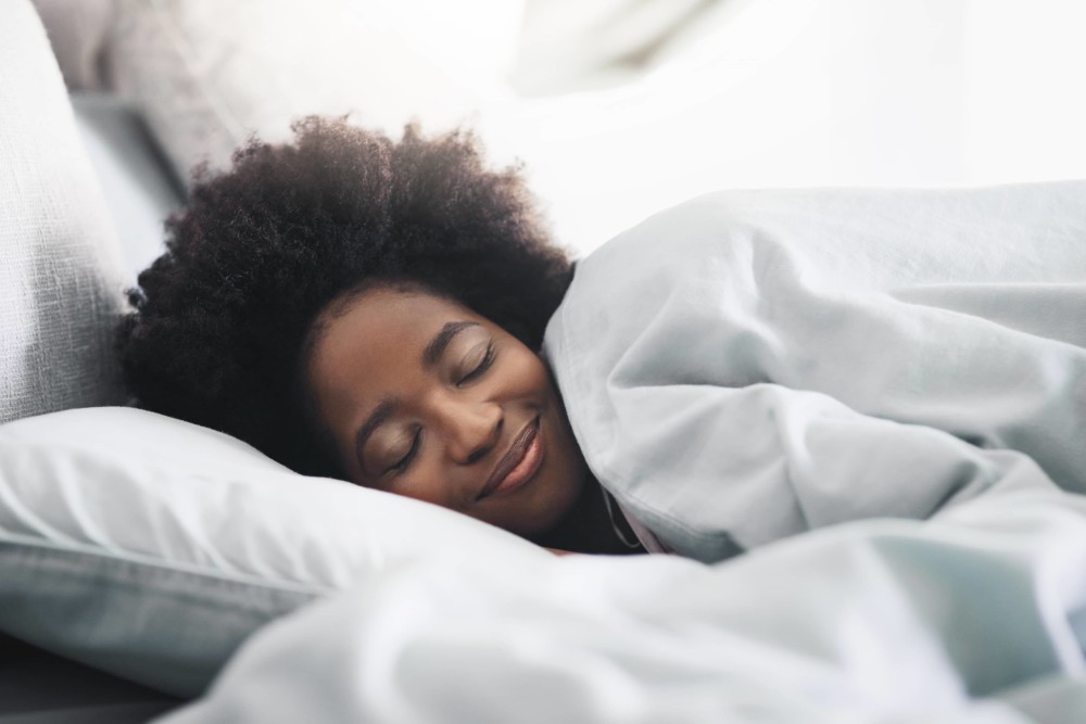 Person smiling while aspleep in bed