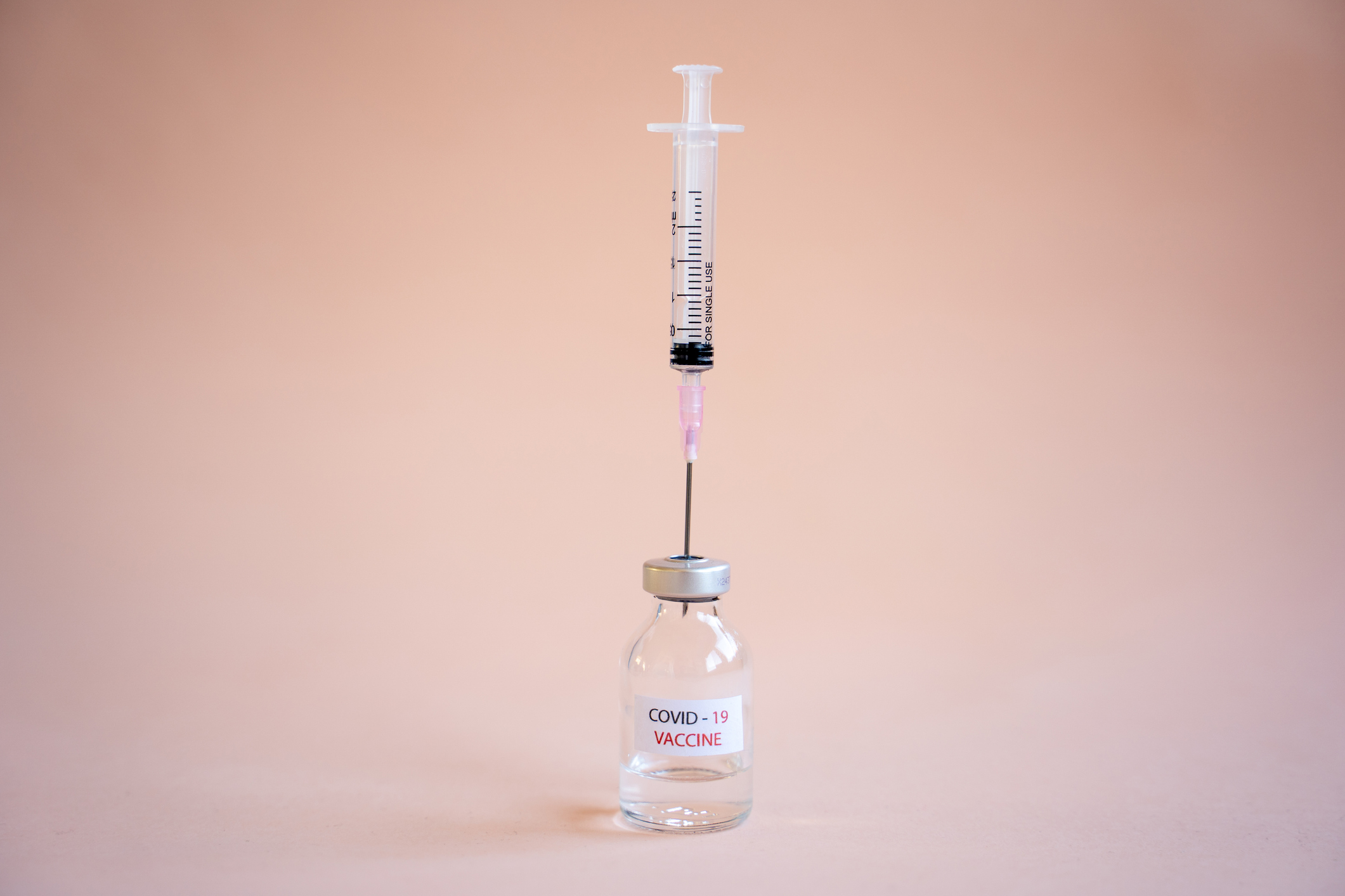 New COVID-19 Vaccine on pink background