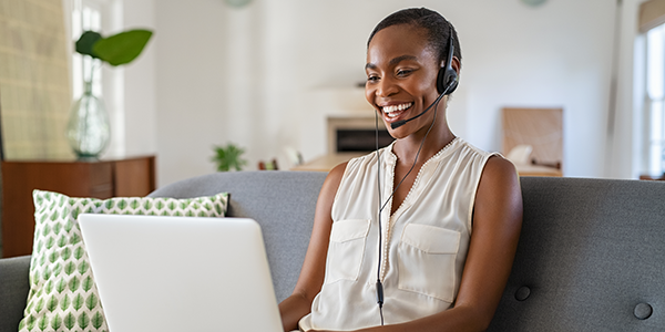 Woman working from her couch at home