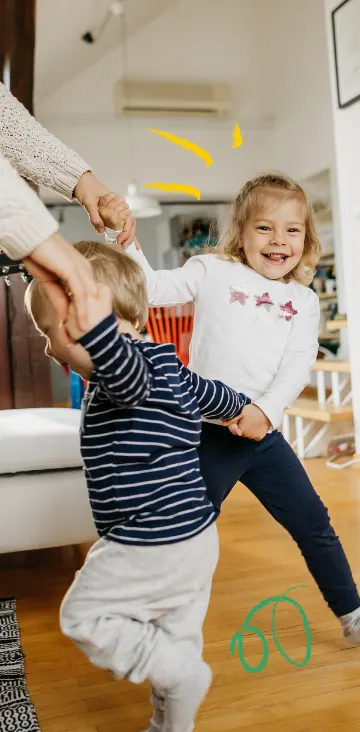 Image of family dancing in living room - about us hero image