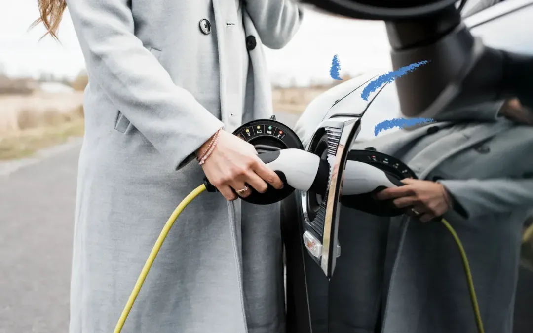 Woman plugging in a charger to her electric vehicle