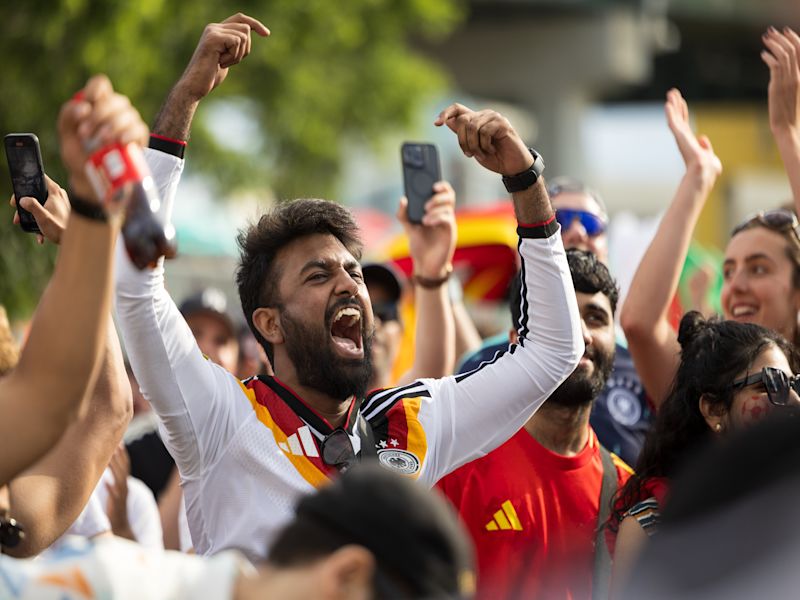 Close up of a fan in a large outdoor crowd.