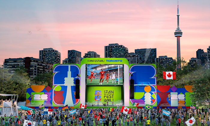 An artist's rendering of a large stage at FIFA Fan Festival Toronto with a large screen showing a soccer game above performers on stage. A crowd stands in front of the stage with the Toronto skyline and CN Tower in the background.