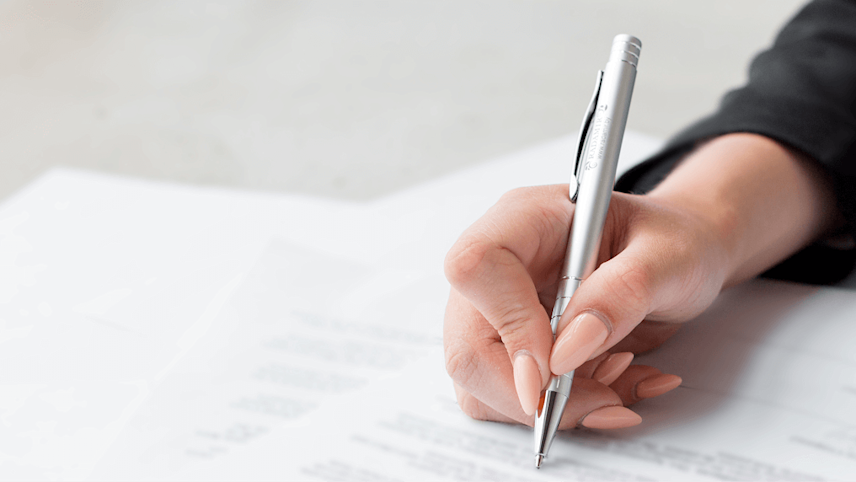 Woman signing a policy document