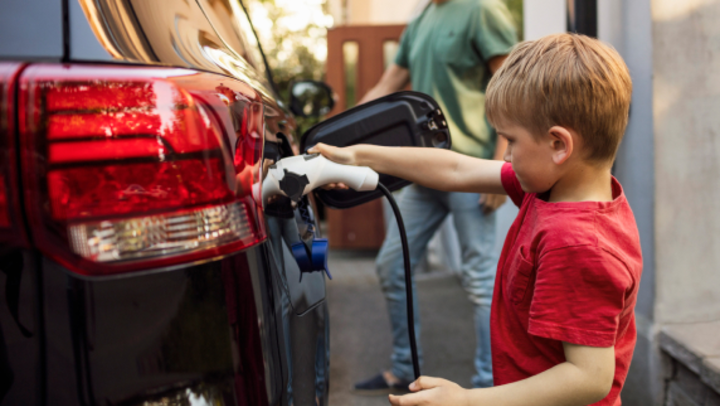 Child plugging in electric car