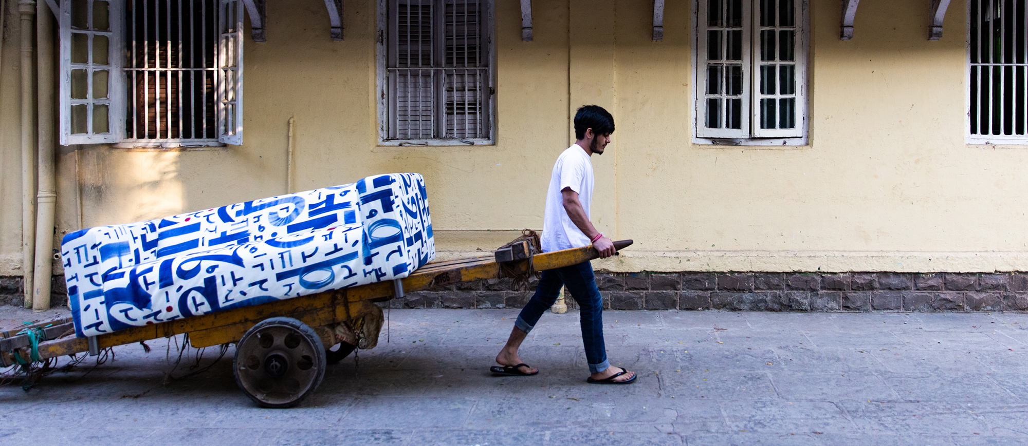 Person carrying furniture on trailer 