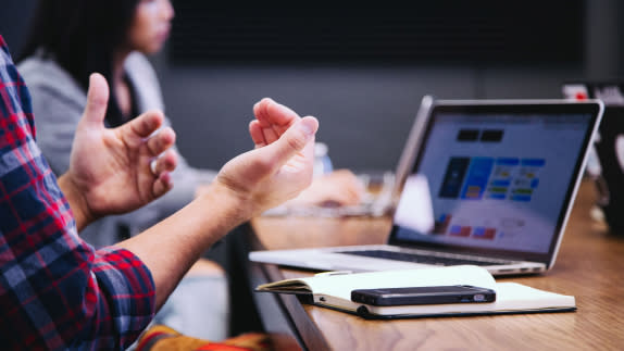 Person talking with their hands in a meeting