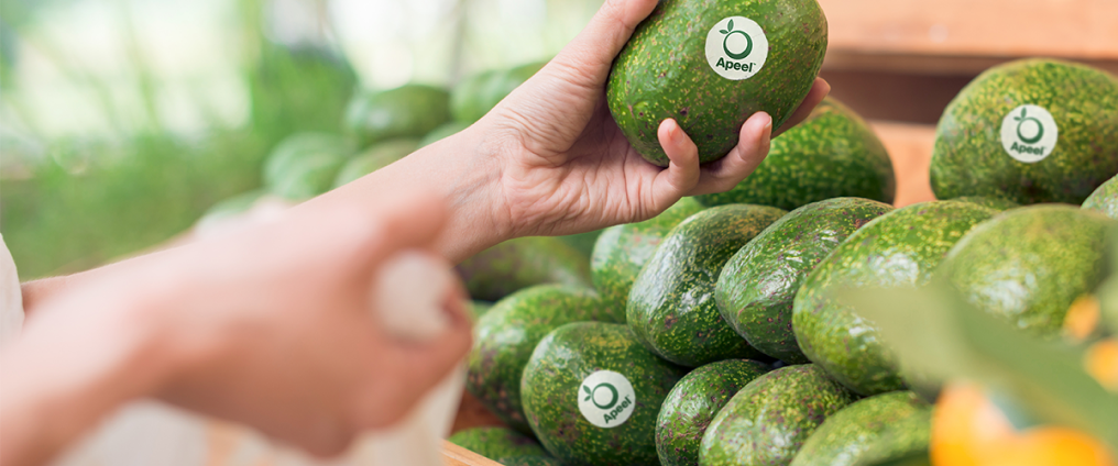 person selecting fruit from shelf